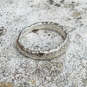 silver textured ring on grey stone background