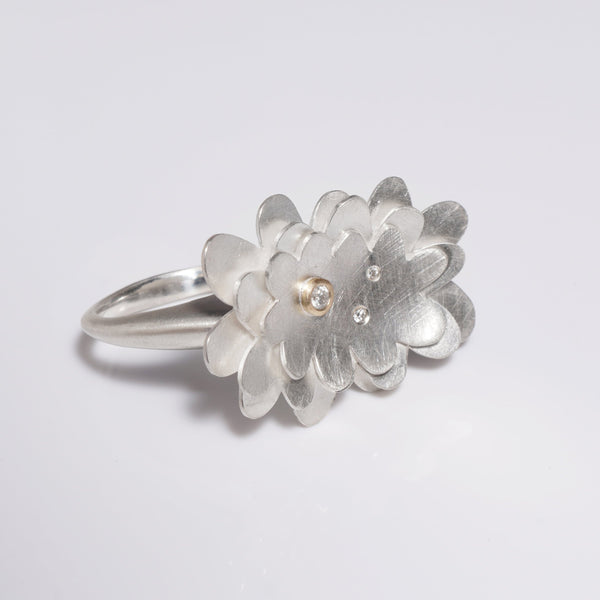 sterling silver abstract flower ring with three diamonds, one set in gold