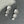 Silver floral earrings on a gray surface