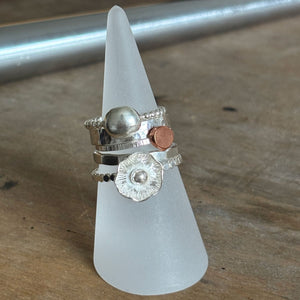 silver stacking rings on a ring cone