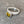 silver ring with green tourmaline stone on a stone prop