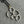 sterling silver lotus outline necklace with oxidised chain and gold connector on grey background