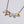 sterling silver necklace with 24k gold keum boo, hanging from an oxidised chain